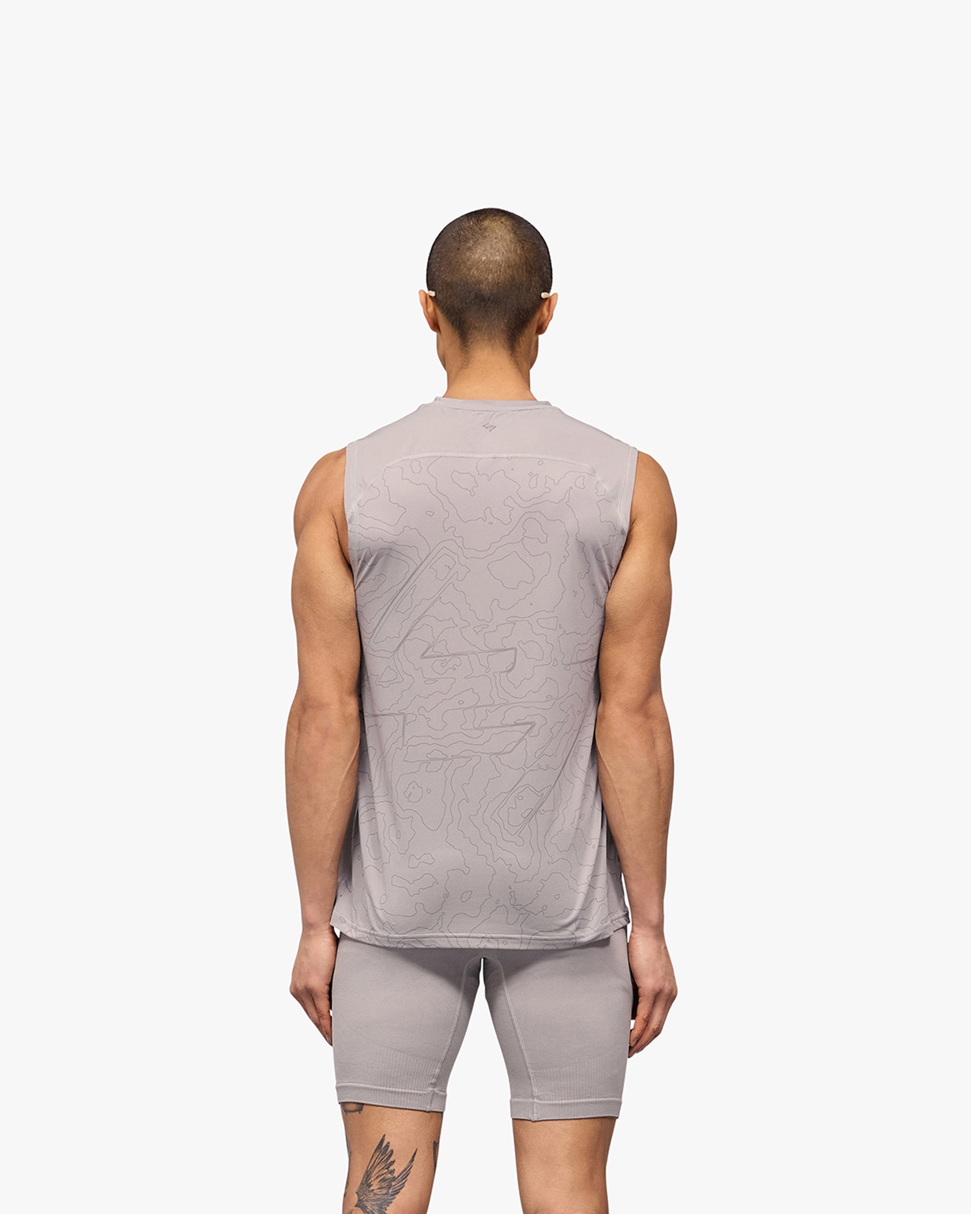 Man wearing a grey running tank on a plain white background | 247 Contour Run Tank in Titanium | Breathable sweat-wicking running tank | 247 T-Shirts | Represent Clo