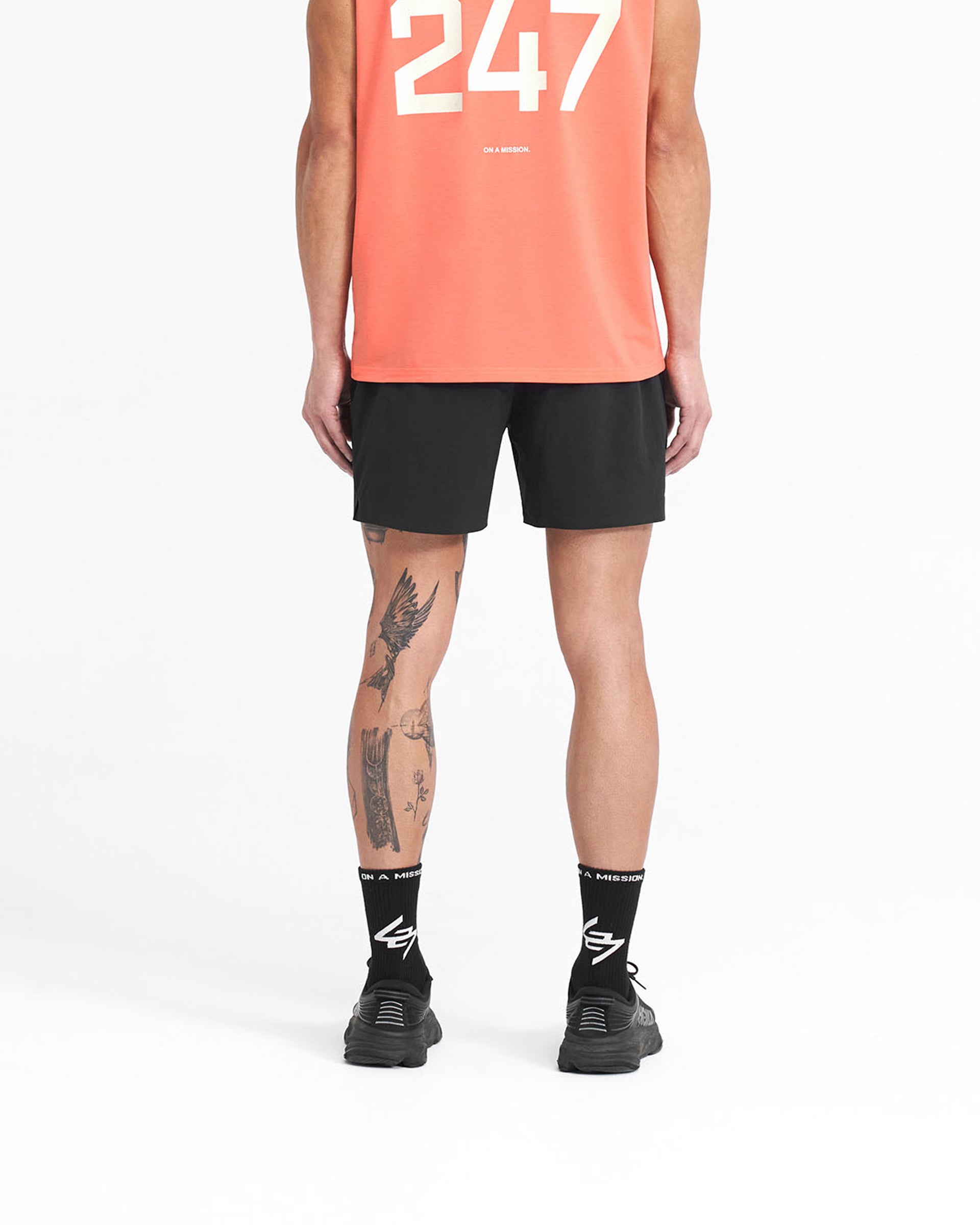 Man wearing black gym shorts on a plain white background | 247 Fused Shorts in Black | Gym shorts with 4 way stretch and internal drawcord | 247 Shorts | Represent Clo