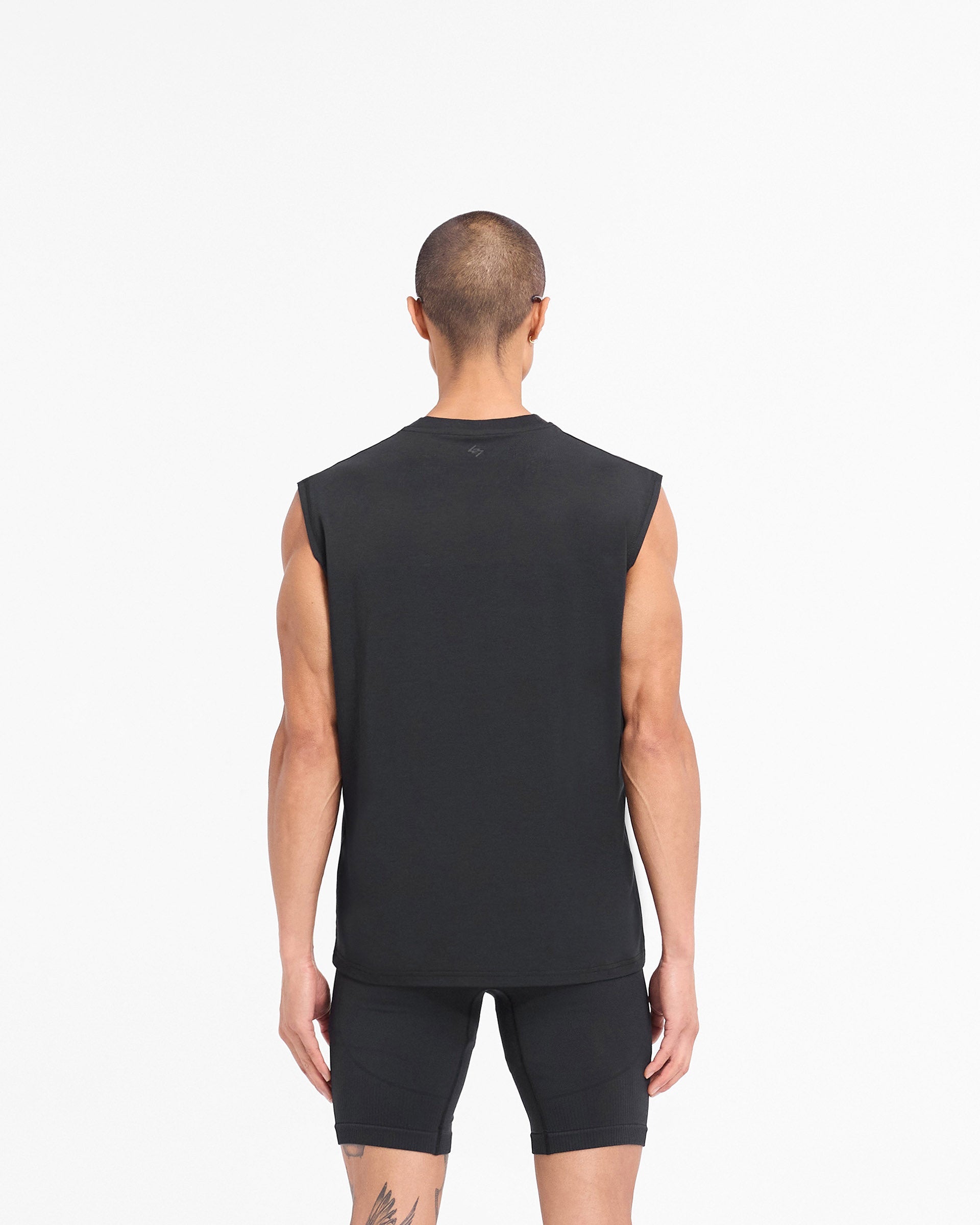 Man wearing a black gym tank top on a plain white background | 247 DNA Oversized Tank in Black | Quick drying lightweight oversized tank | 247 T-Shirts | Represent Clo